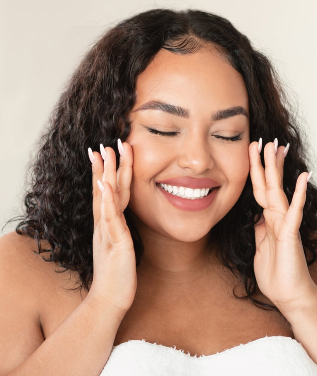 Woman holding her face smiling